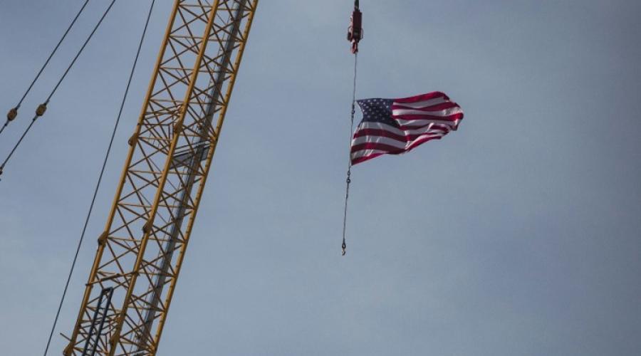 US flag coming down a crane