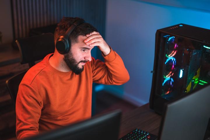 Software developer wearing a headset to filter out unwanted noise